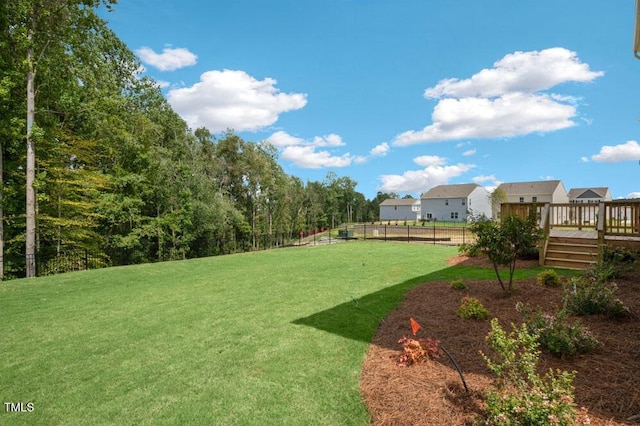 view of yard with fence and a wooden deck