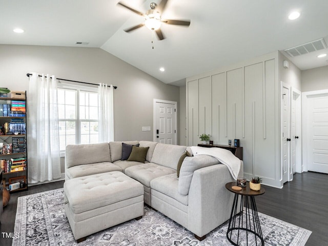 living room featuring lofted ceiling, wood finished floors, visible vents, and a ceiling fan