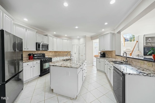 kitchen with appliances with stainless steel finishes, a sink, and crown molding