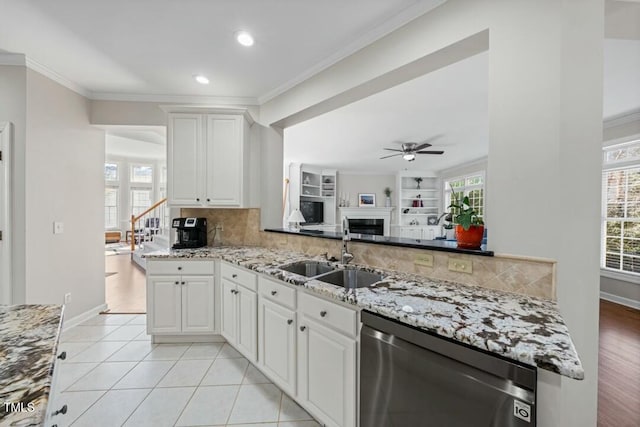 kitchen with tasteful backsplash, dishwasher, ceiling fan, crown molding, and a sink