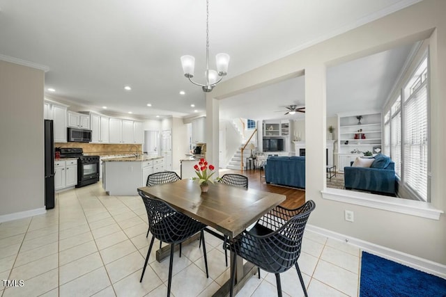 dining room featuring light tile patterned floors, crown molding, ceiling fan with notable chandelier, and baseboards