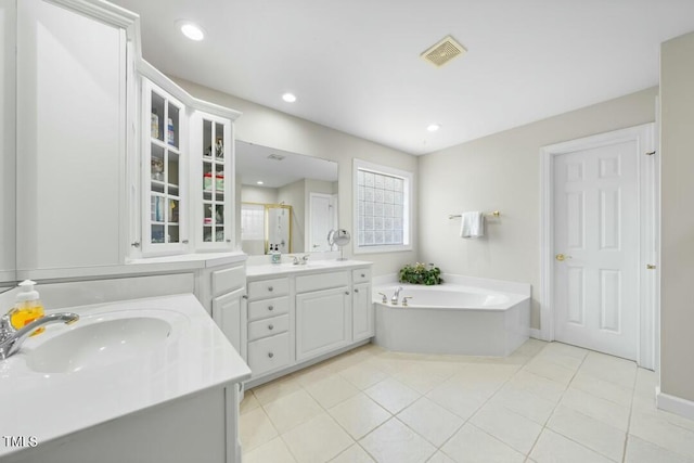 bathroom with a bath, a sink, visible vents, and a shower stall