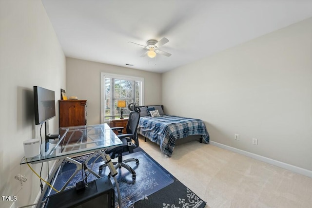 carpeted bedroom with visible vents, baseboards, and a ceiling fan