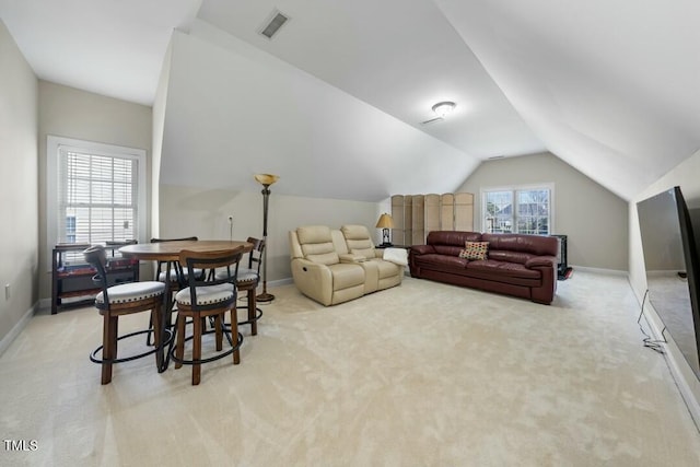 living room with baseboards, visible vents, and vaulted ceiling