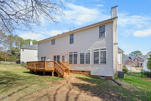 rear view of house with a chimney, fence, a deck, a yard, and central AC