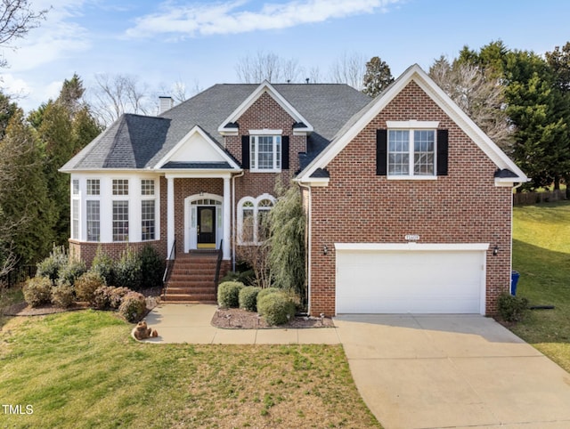 view of front of property featuring a garage, brick siding, driveway, a chimney, and a front yard