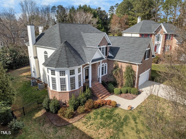 traditional-style house with crawl space, a chimney, fence, and brick siding