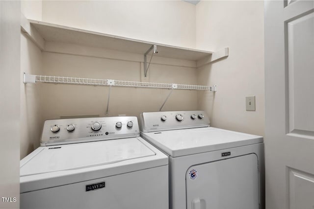 clothes washing area featuring laundry area and separate washer and dryer