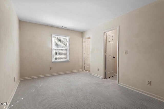 unfurnished bedroom with carpet flooring, visible vents, and baseboards