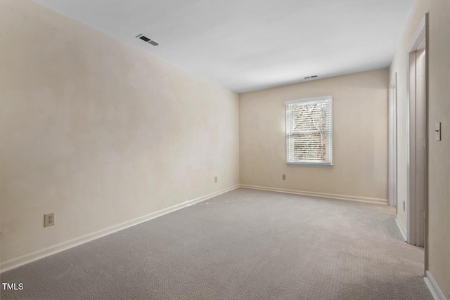 unfurnished bedroom featuring carpet flooring, visible vents, and baseboards