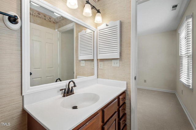 bathroom featuring baseboards, visible vents, and vanity