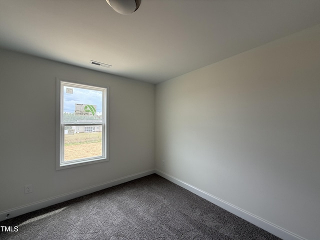 394 Springtooth Dr, Zebulon, NC 27597 - unfurnished room featuring dark carpet and baseboards