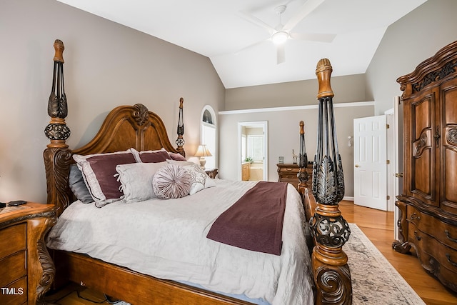 bedroom with lofted ceiling, light wood-type flooring, ceiling fan, and connected bathroom