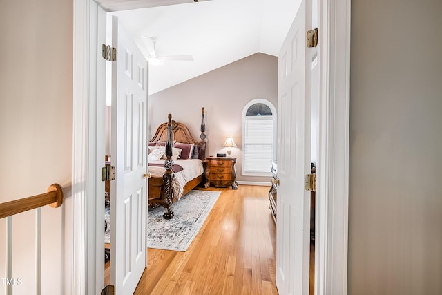 bedroom featuring a ceiling fan, lofted ceiling, and light wood finished floors