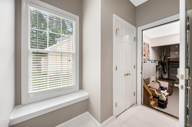 entryway featuring plenty of natural light and baseboards