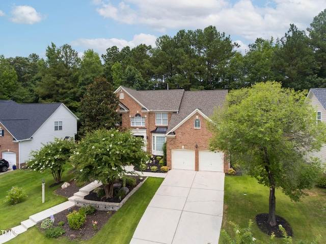 traditional-style home with brick siding, a shingled roof, a front yard, a garage, and driveway