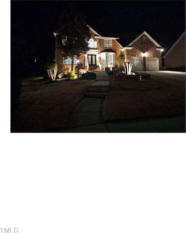 view of front facade with driveway and an attached garage