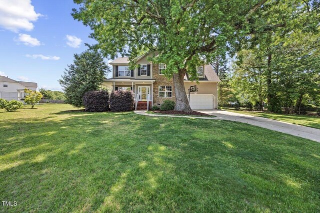 view of front of home with an attached garage, driveway, and a front yard