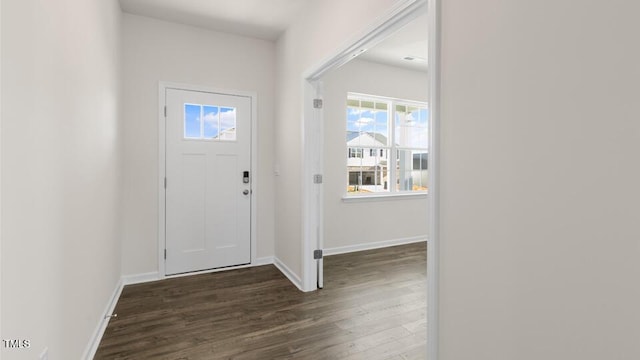 foyer with baseboards and dark wood finished floors