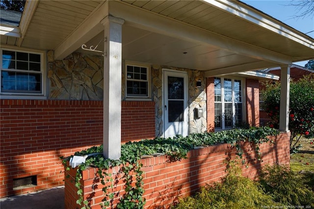 entrance to property with crawl space and brick siding