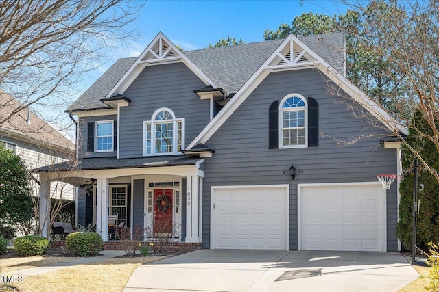 view of front of house featuring driveway, roof with shingles, a porch, and an attached garage