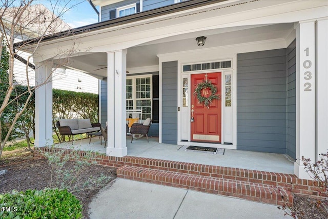 view of exterior entry featuring covered porch