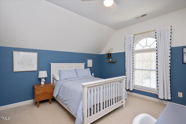 carpeted bedroom featuring visible vents, baseboards, ceiling fan, and vaulted ceiling