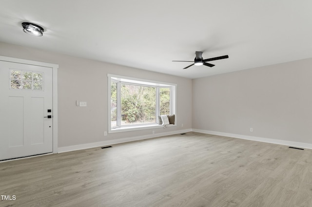 interior space featuring visible vents, baseboards, light wood-type flooring, and ceiling fan