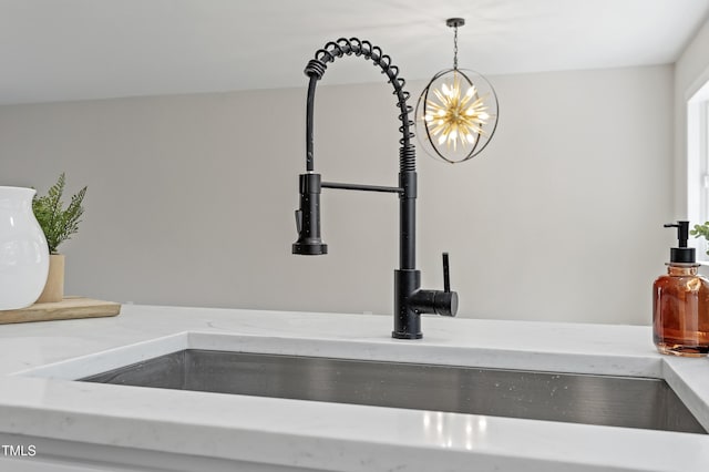 interior details with a sink, decorative light fixtures, and a notable chandelier