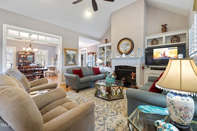 5204 Sandbridge Rd, Bailey, NC 27807 - living area with a chandelier, a warm lit fireplace, ceiling fan, high vaulted ceiling, and wood finished floors
