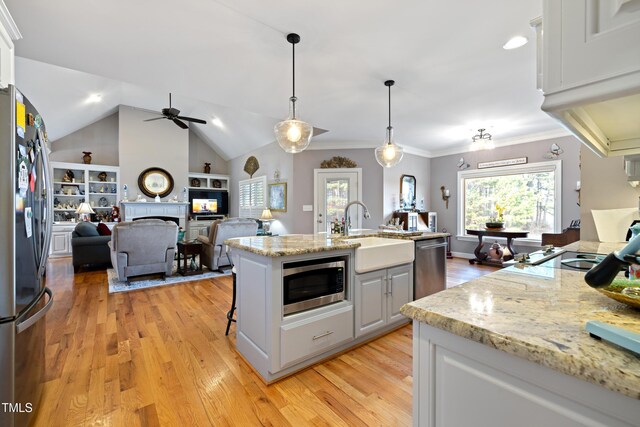 5204 Sandbridge Rd, Bailey, NC 27807 - kitchen with appliances with stainless steel finishes, a sink, white cabinetry, light wood finished floors, and vaulted ceiling
