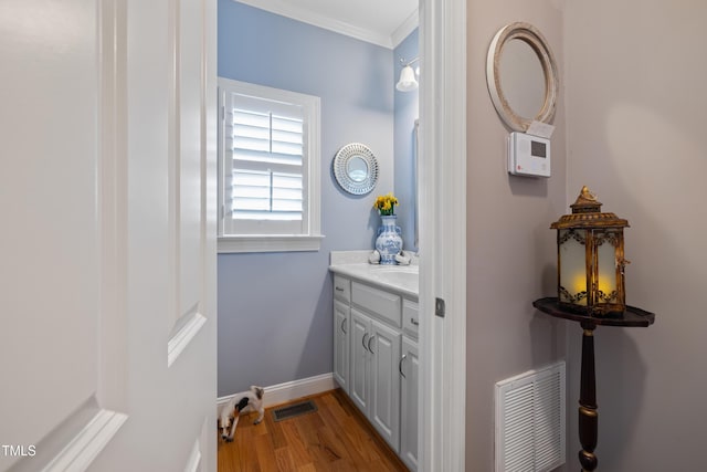 5204 Sandbridge Rd, Bailey, NC 27807 - bathroom with vanity, wood finished floors, crown molding, and baseboards