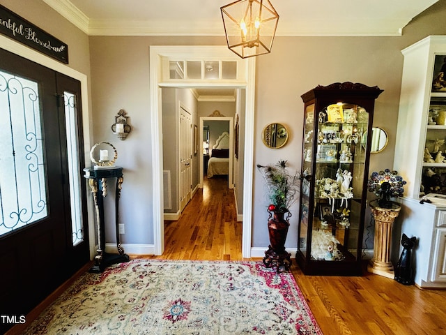 5204 Sandbridge Rd, Bailey, NC 27807 - foyer entrance with ornamental molding, wood finished floors, a chandelier, and baseboards
