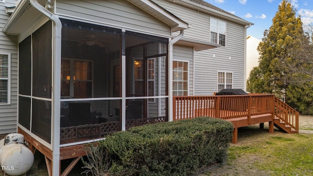 exterior space featuring a sunroom and a wooden deck