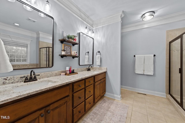 full bathroom with a shower stall, crown molding, a sink, and tile patterned floors