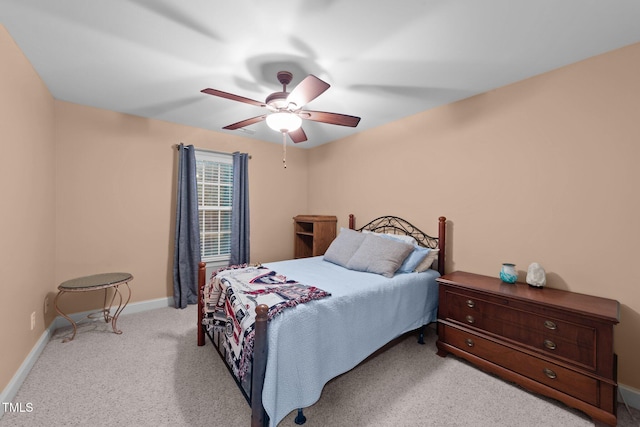 carpeted bedroom featuring ceiling fan and baseboards