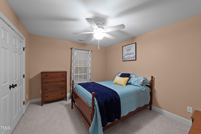 carpeted bedroom with a ceiling fan, baseboards, visible vents, and a closet