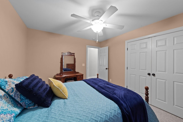 carpeted bedroom with ceiling fan and a closet