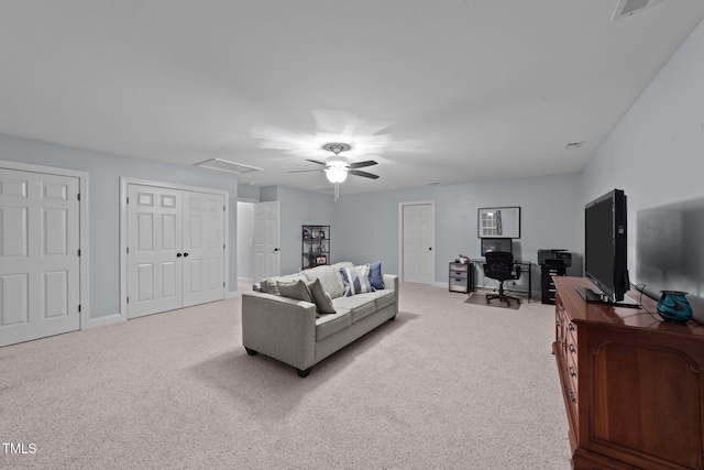 living room featuring carpet floors, visible vents, ceiling fan, and baseboards