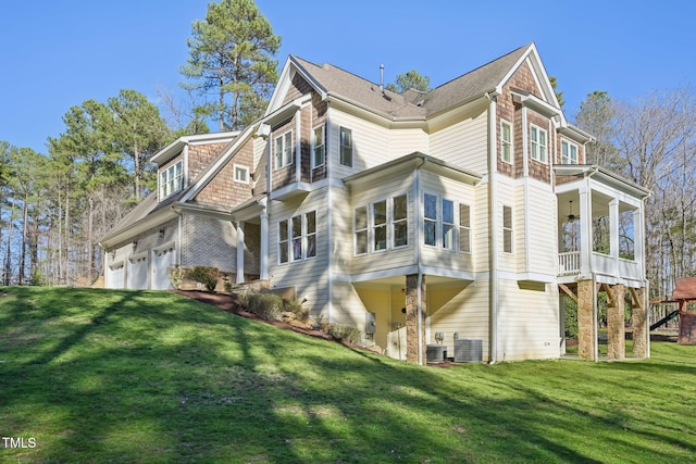 view of home's exterior with cooling unit and a yard