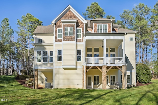 back of house with cooling unit, a lawn, a balcony, and a ceiling fan