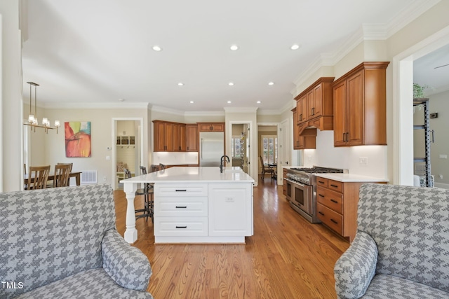 kitchen featuring visible vents, high quality appliances, light countertops, and light wood-style floors