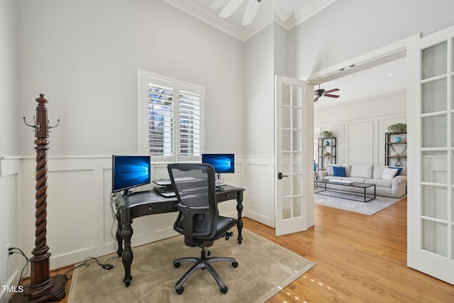 office area with crown molding, a decorative wall, french doors, and ceiling fan