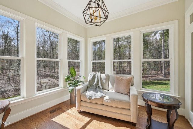 sunroom / solarium featuring a notable chandelier and visible vents