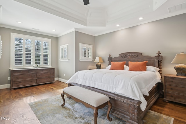 bedroom featuring crown molding, wood finished floors, visible vents, and baseboards