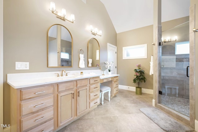 bathroom featuring lofted ceiling, a stall shower, tile patterned flooring, baseboards, and vanity