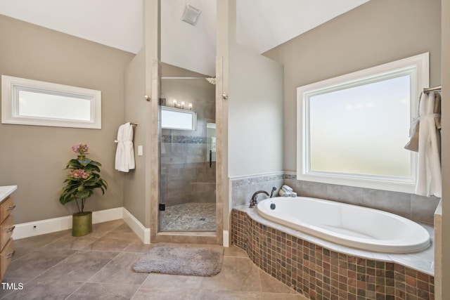 full bath featuring a bath, a stall shower, vanity, and baseboards