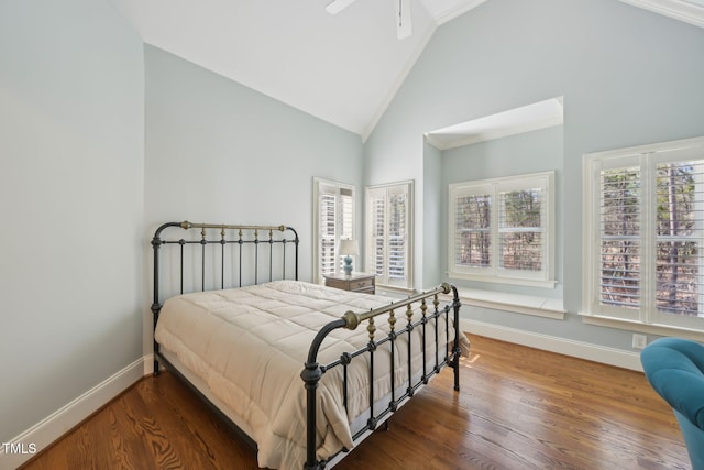 bedroom with baseboards, high vaulted ceiling, and wood finished floors