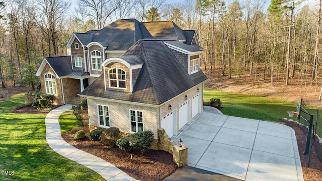 view of property exterior with stone siding, a yard, concrete driveway, a garage, and brick siding