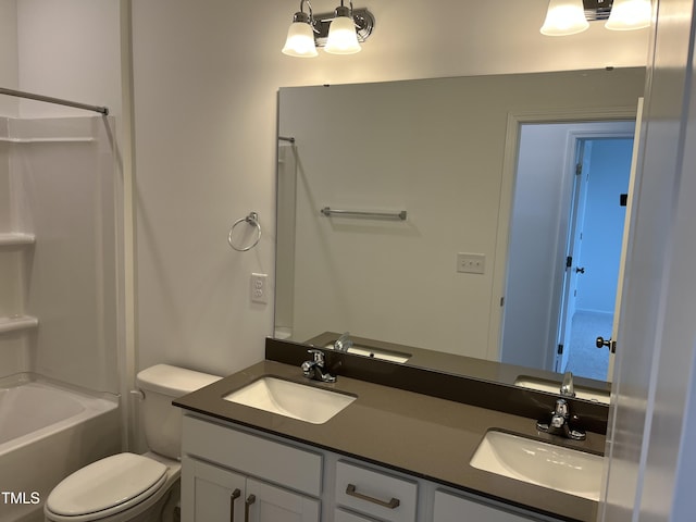bathroom with toilet, double vanity, a sink, and bathtub / shower combination